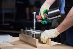 man with rivet gun working on a riveting work