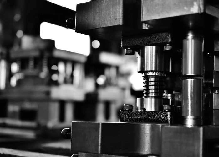 Sheet metal stamping die in close shot at black and white